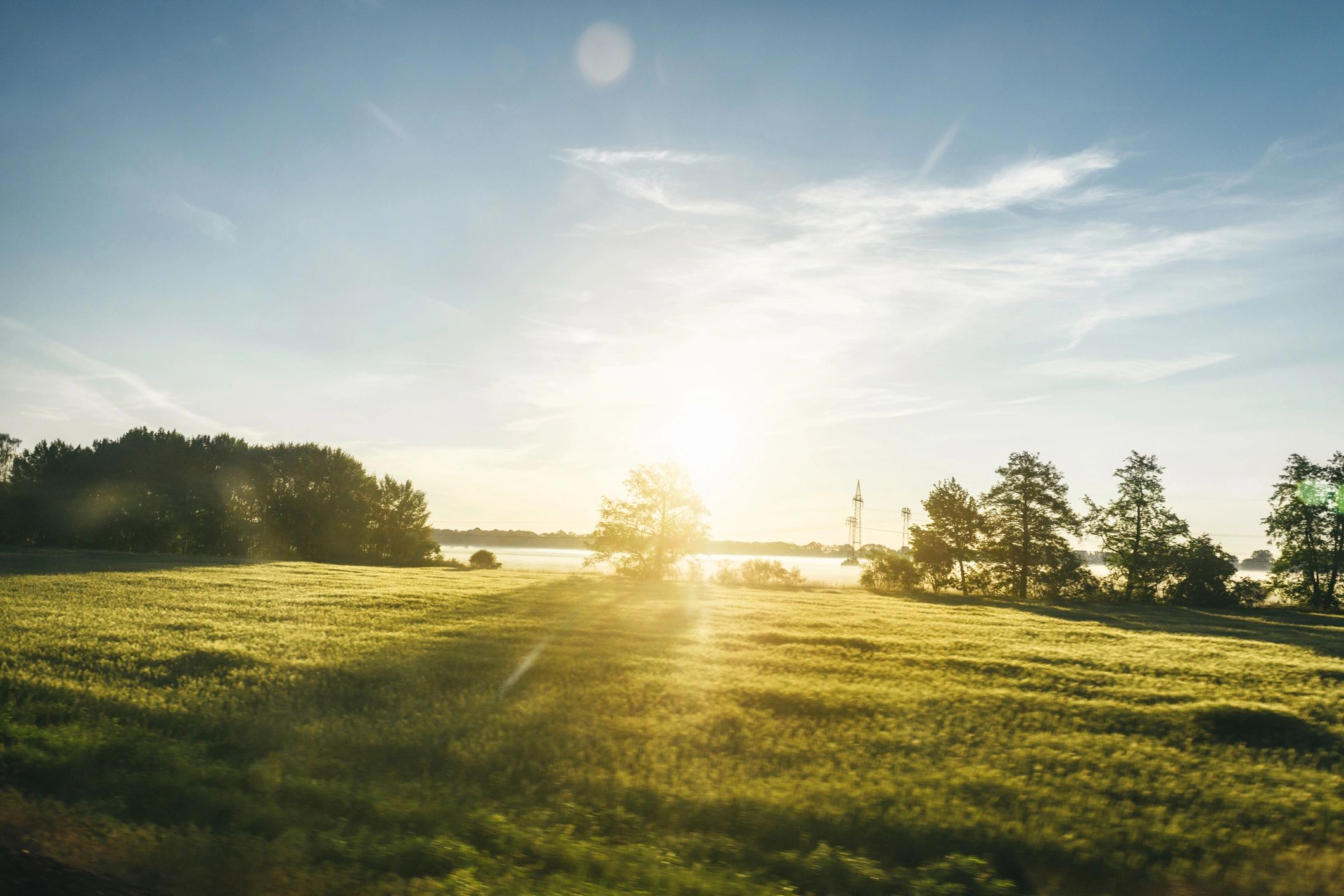 Landscape at sunrise seen through a window